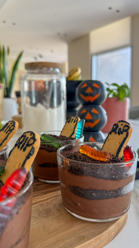 This weekend, my daughter had one clear request:
“Can we make a Halloween recipe together?”

So we put on our aprons, gathered a few ingredients, and created something simple, spooky… and totally delicious:
🍫 Classic Chocolate Mousse with a Halloween Graveyard Twist.

This dessert is a true family favorite — rich, airy chocolate mousse layered with Oreo “dirt” and playful Halloween decorations. And the best part? It’s so fun to make with kids.
